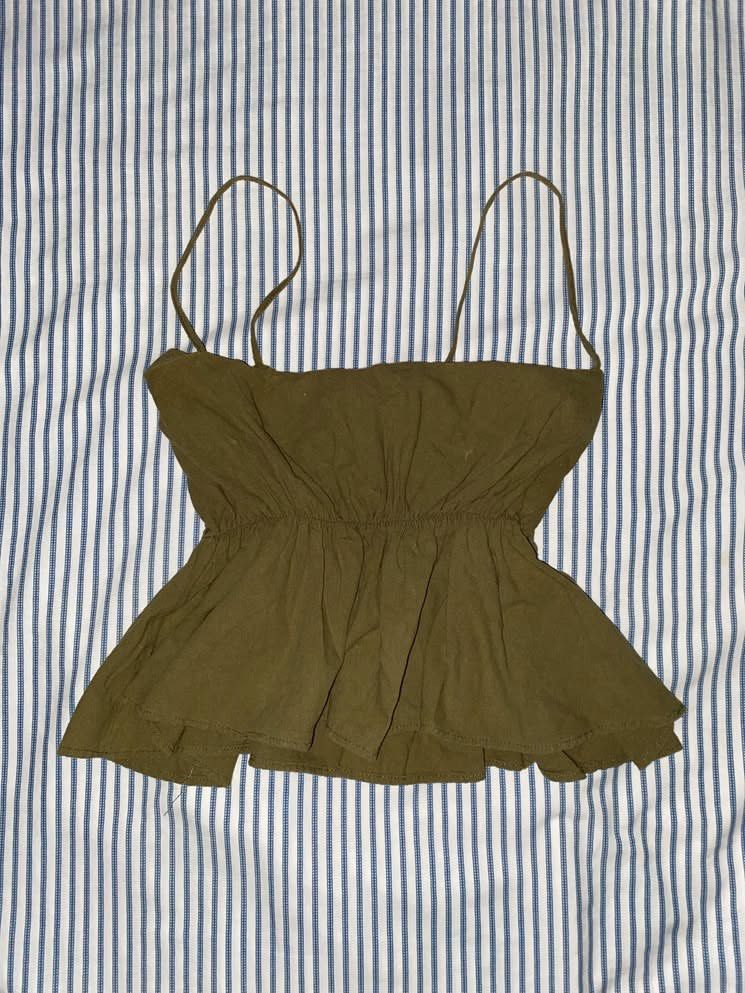 Olive Green Peplum Camisole Top (Category: Sleeveless) located in Manila. Submitted by _dayanughhhh (Listing ID 1460871754, Image 1). Description: - Olive green camisole top - Spaghetti straps - Gathered waist detail - Peplum hem - Lightweight fabric with a slightly crinkled texture - Perfect for pairing with high-waisted bottoms - Easy to dress up or down.