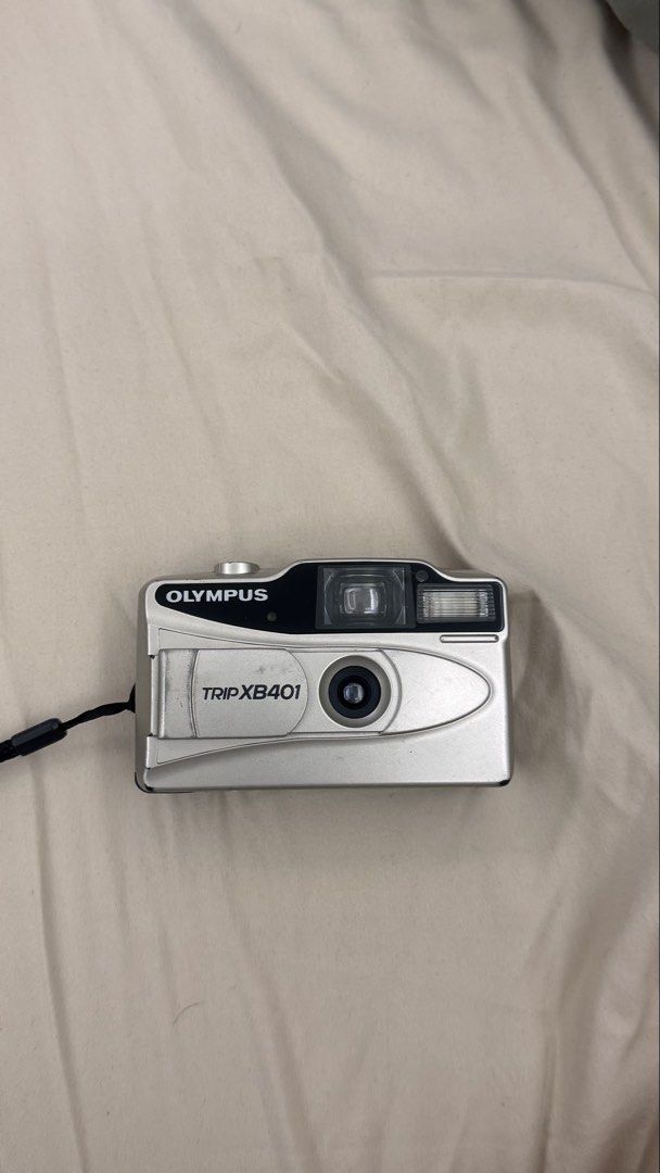 Olympus Trip XB401 (Category: Cameras) located in Santa Rosa. Submitted by cmasangkay (Listing ID 1460814450, Image 1). Description: Condition: Good vintage condition • Tested and working • Flash works and activates depending on the lighting/ambient light conditions • Lens appears clear • Minor dust particles visible inside the viewfinder • Minor scratches/scuffs from normal use due to age • Comes with wrist strap • Please refer to photos for act
