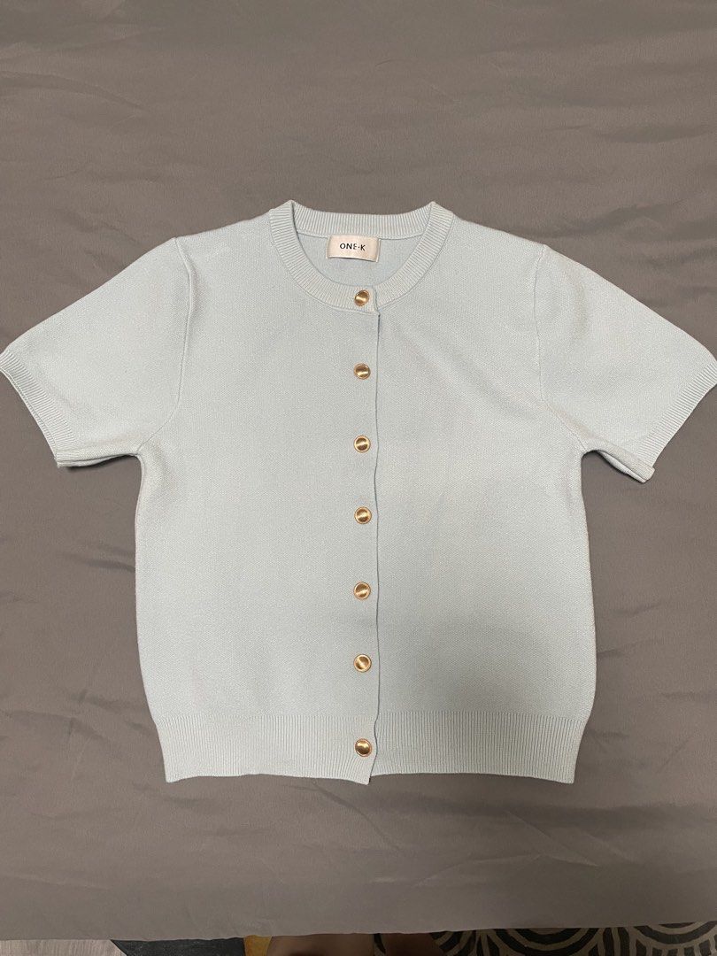 One K BKK Knit Cardigan (Category: Blouses) located in Quezon City. Submitted by mfordma (Listing ID 1460889432, Image 1). Description: BRAND NEW Originally bought for 590.00 Doing a little closet decluttering! ✨ Letting go of some pieces that are still in great condition and looking for a new home. 🤍 Brand: ONE-K Size: Free size Color: Light blue Description: - Short sleeve slightly stretchable cardigan - Features functional gold hardware down 
