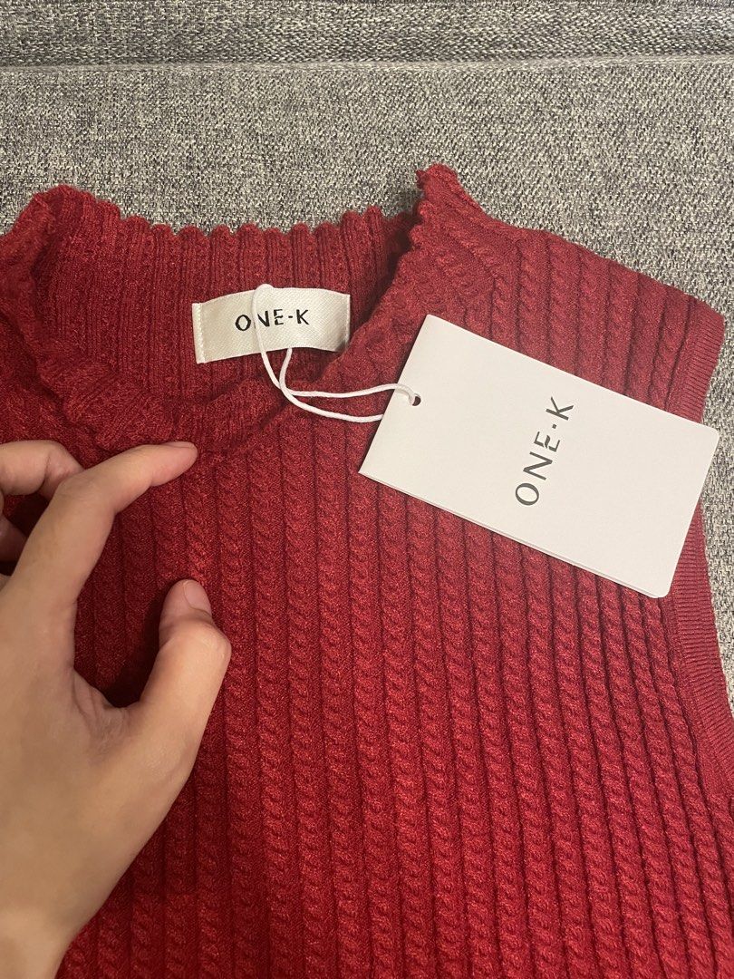 One K BKK Ribbed Turtle Neck Sleeveless (Category: Blouses) located in Quezon City. Submitted by mfordma (Listing ID 1460907702, Image 2). Description: BRAND NEW Originally bought for 480.00 Doing a little closet decluttering! ✨ Letting go of some pieces that are still in great condition and looking for a new home. 🤍 Brand: ONE-K Size: Free size Color: Red Description: - Very stretchable ribbed intricate cable knit detailing top - Mock neck with