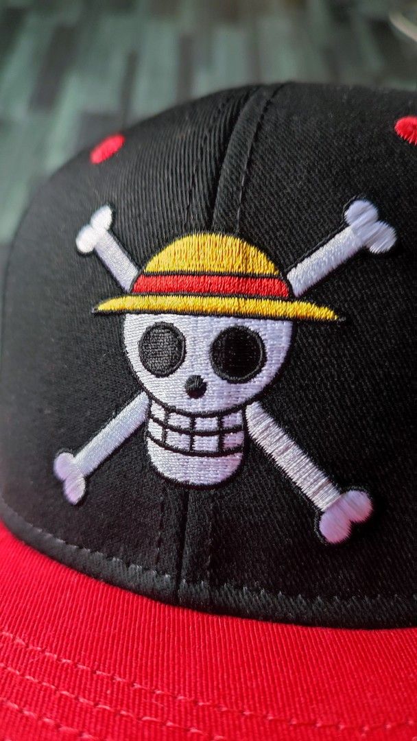 One Piece Straw Hat Pirates Snapback Cap (Category: Caps & Hats) located in Manila. Submitted by janyvony_315 (Listing ID 1460907234, Image 3). Description: - Black snapback cap with a striking red brim. - Features the iconic One Piece Straw Hat Pirates Jolly Roger logo embroidered on the front. - Red button on top and red eyelets for added detail. - Perfect for any dedicated One Piece fan! - Adjustable strap at the back for a comfortable, custom