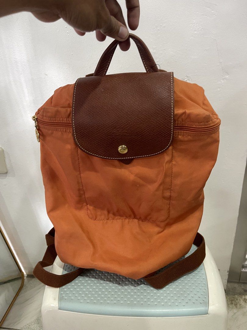 orange nylon Longchamp Le Pliage Backpack (Category: Luxury Bags & Wallets) located in Manila. Submitted by john_robert00 (Listing ID 1460891479, Image 1). Description: orange nylon Longchamp Le Pliage Backpack Issue : none Pm sa details.