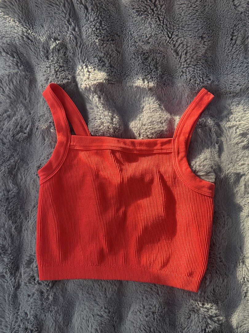 Orange Ribbed Cropped Tank Top (Category: Sleeveless) located in Valenzuela. Submitted by mar1ascloset_ (Listing ID 1460892002, Image 1). Description: - Worn once xs-s - Orange ribbed cropped tank top - Features a square neckline and thick straps - Made from stretchy material for a comfortable fit - Versatile piece: great for layering or wearing on its own - Pairs well with jeans or shorts.