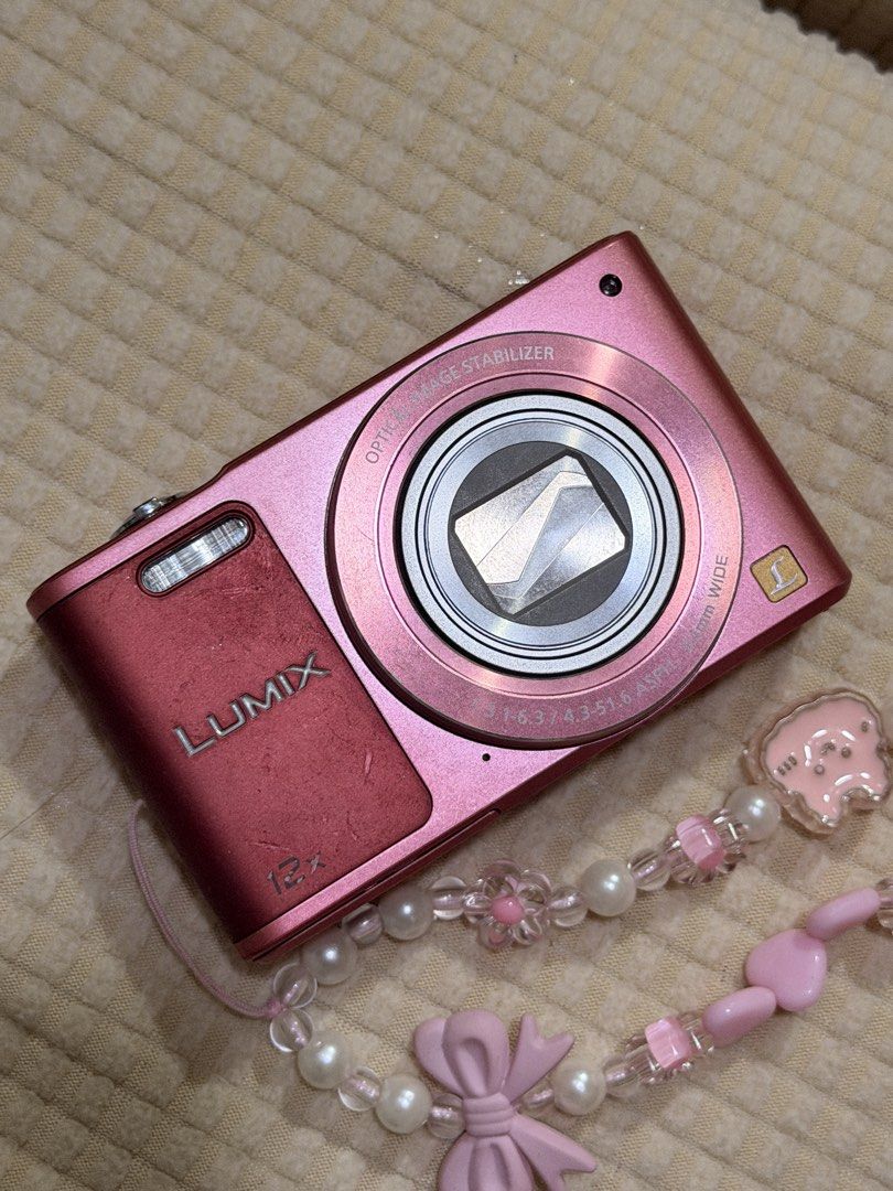 Panasonic Lumix DMC SZ-10 Pink Digital Camera (Category: Cameras) located in Manila. Submitted by nikkitamarchei (Listing ID 1460815954, Image 2). Description: - Pink Panasonic Lumix digital camera - 12x optical zoom - Flip-up screen for easy viewing - Minor cosmetic scratches on screen, fully functional - Comes with battery, SD Card, and cute beaded strap - Ideal for everyday use and travel Bought for ₱15,000, selling for ₱12,000 (price is negot
