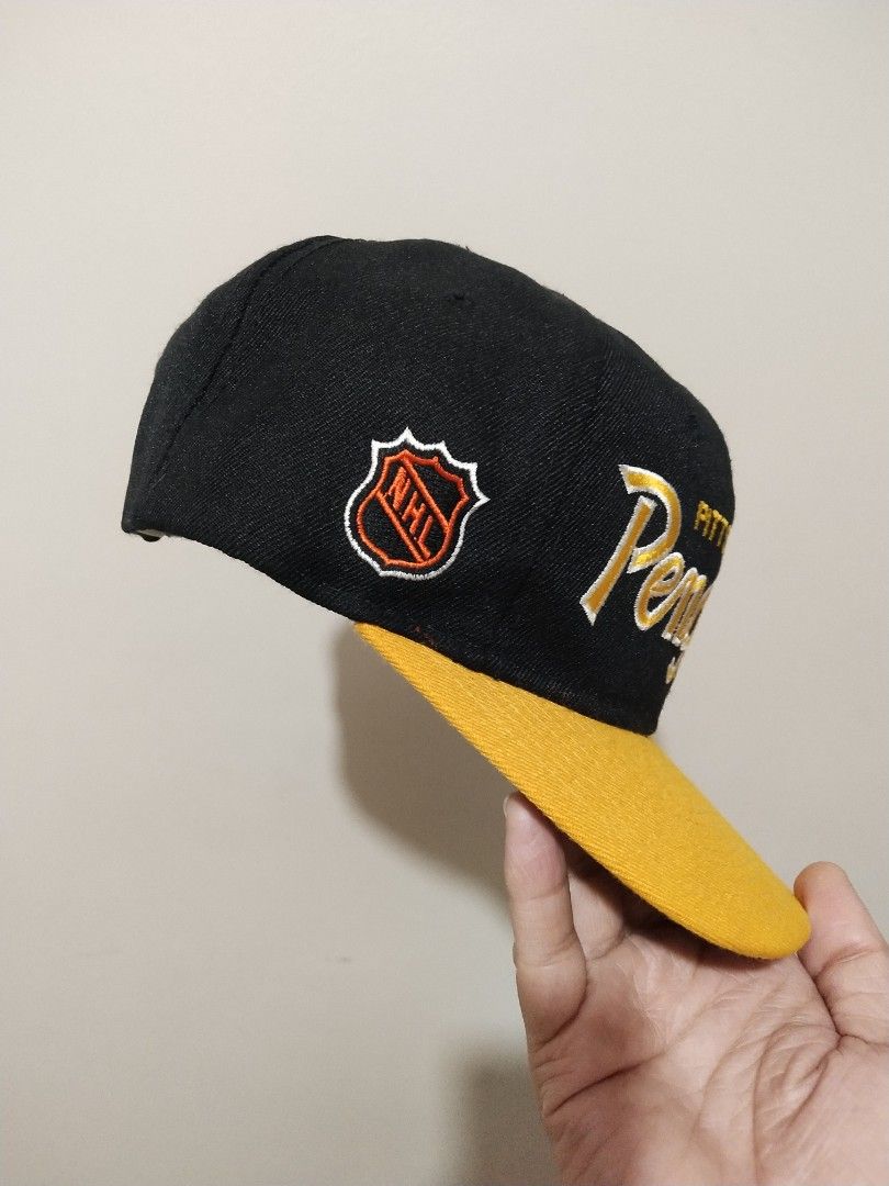 Pittsburgh Penguins NHL Snapback Cap (Category: Caps & Hats) located in Manila. Submitted by drud91296 (Listing ID 1460876116, Image 3). Description: - vintage hat - Black and yellow Pittsburgh Penguins snapback cap - Features team name embroidered on the front - NHL logo embroidered on the side - Classic green underbrim - A must-have for any dedicated Penguins fan!.