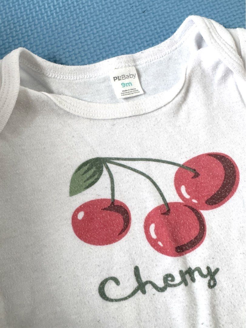 PL Baby White Cherry Print Onesie 9m (Category: Babies & Kids Fashion) located in Muntinlupa City. Submitted by Tins_preloved (Listing ID 1460892333, Image 3). Description: Cute white baby onesie, size 9 months. Features a cherry print and 'Cherry' text. Easy snaps for diaper changes. Soft cotton, perfect for everyday..