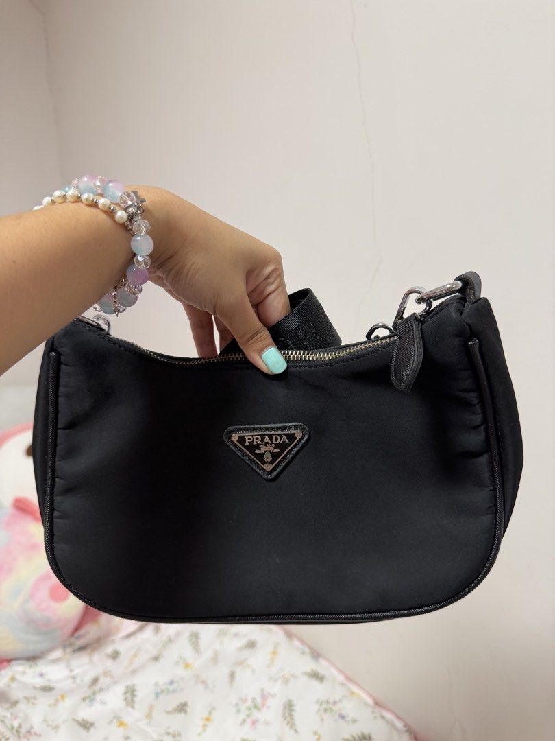 Prada Nylon Shoulder Bag Black (Category: Luxury Bags & Wallets) located in Manila. Submitted by thecasaisabel (Listing ID 1460725669, Image 1). Description: - Black Prada Shoulder Bag - Durable Nylon Material - Front Zipper Pocket for easy access - Spacious Main Compartment - Elegant Silver Hardware Details - Includes Detachable Strap for versatile wear - Interior is clean and well-maintained.