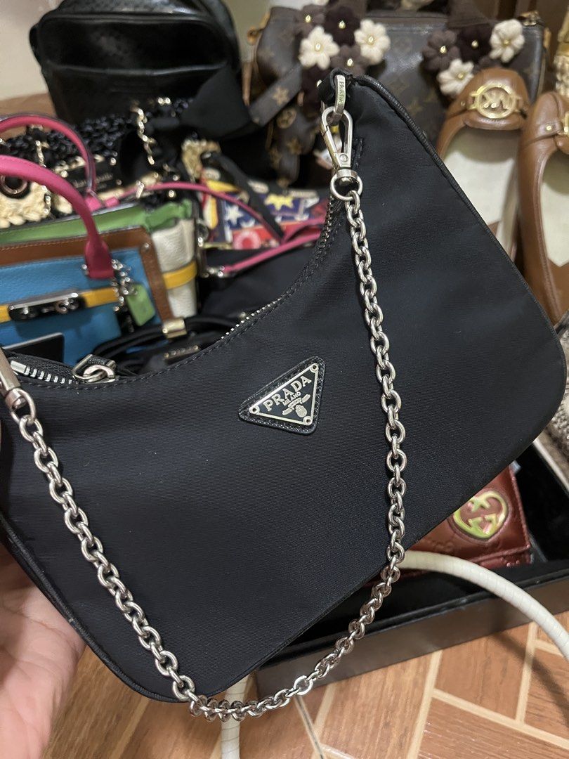 Prada Nylon Shoulder Bag with Chain Strap (Category: Luxury Bags & Wallets) located in Manila. Submitted by anjucarl (Listing ID 1460793804, Image 1). Description: - Authentic Prada shoulder bag - Black nylon material - Silver chain strap - Zipper closure - Interior features Prada logo lining - 'Made in Italy 175' tag - Ideal for everyday use.