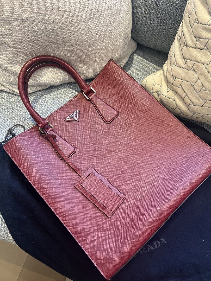Prada Saffiano Leather Document Tote Bag (Category: Luxury Bags & Wallets) located in Muntinlupa City. Submitted by goodsbymjp (Listing ID 1460793538, Image 3). Description: - Authentic Prada tote bag - Made with genuine red Saffiano leather - Interior: Black leather with zip pocket and card slots - Comes with original Prada dust bag - Ideal for work or everyday use.