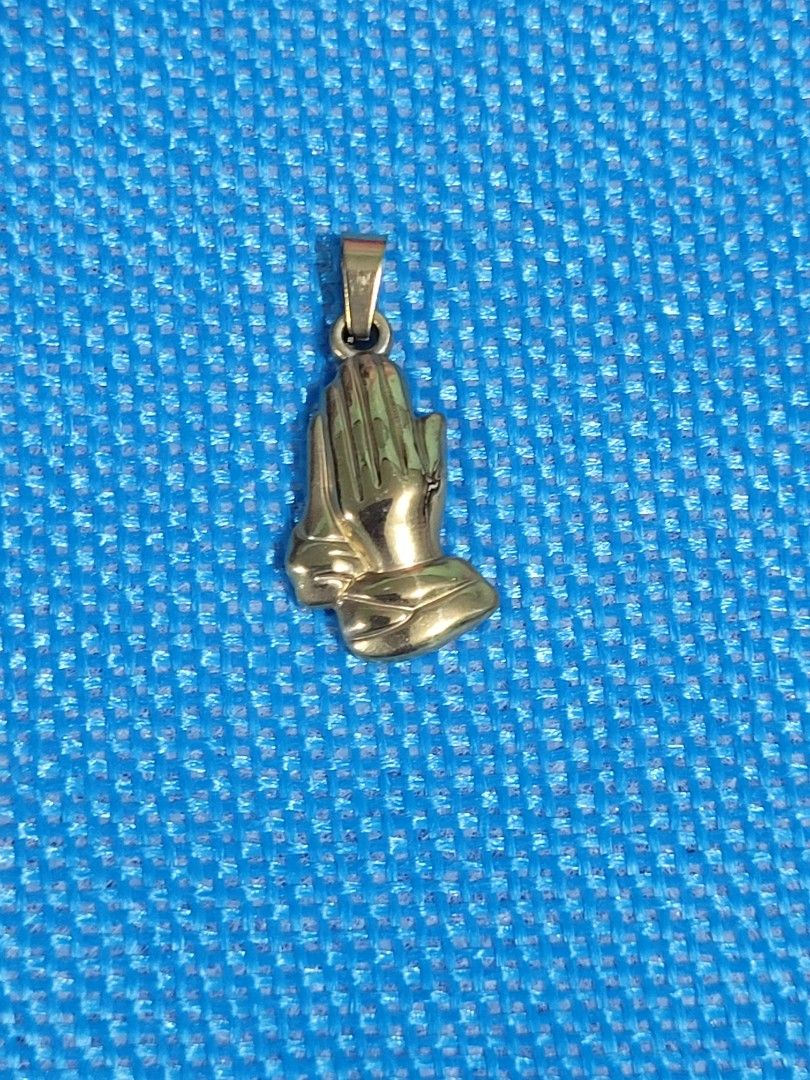 PRAYING HANDS STAINLESS GOLD PENDANT (Category: Religious Items) located in Makati City. Submitted by juriexpi (Listing ID 1460899911, Image 1). Description: PRAYING HANDS STAINLESS GOLD PENDANT Hypo allergenic, pure stainless, non fade, non tarnish, brand new, sealed with jewelry pouch actual photos posted, what you see is what you get.