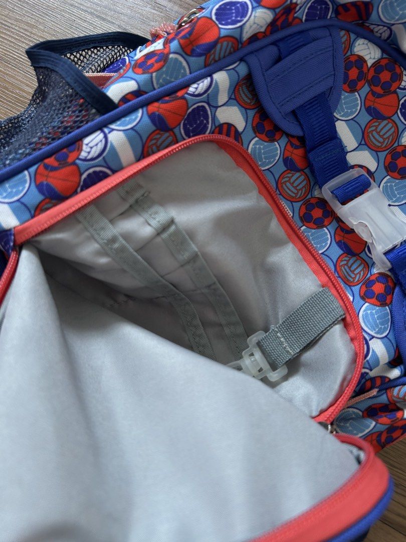 Preloved Lily and Tucker Backpack (Category: Babies & Kids Fashion) located in Pililla. Submitted by momshk (Listing ID 1460751520, Image 2). Description: - Fun backpack with colorful soccer and volleyball print. - Front zippered pocket for easy access. - Side mesh pockets perfect for water bottles. - Comfortable padded shoulder straps. - Main compartment with internal pockets for organization. - Note: Some light marks inside the main compartment