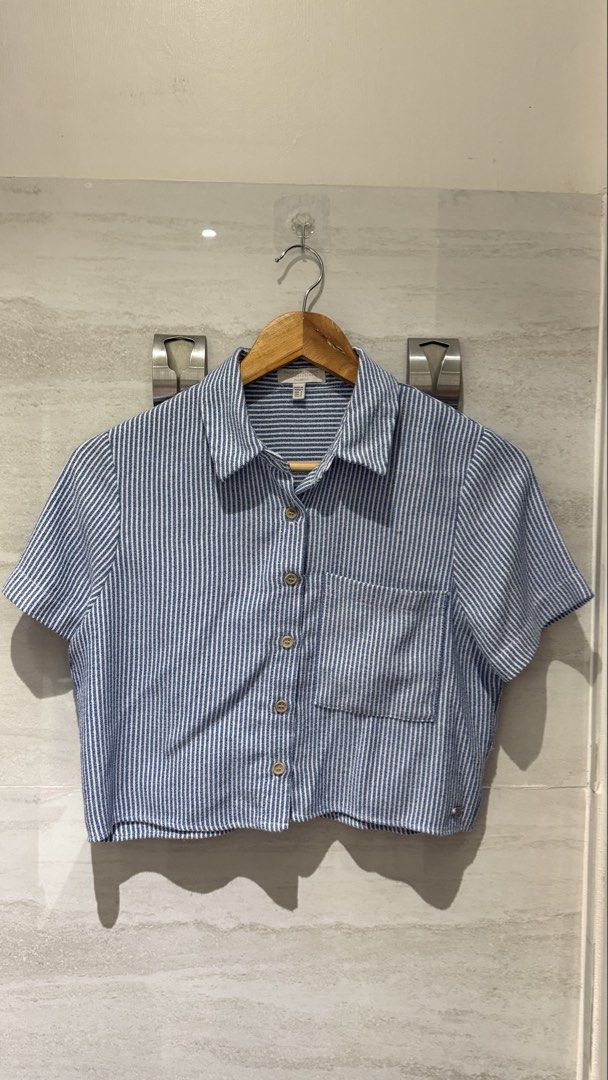 Pull & Bear Blue and White Striped Cropped Shirt (Category: Shirts) located in Caloocan City. Submitted by trishaperezzz (Listing ID 1460758947, Image 1). Description: - Cute cropped shirt from Pull & Bear - Blue and white vertical stripe pattern - Short sleeves - Button-up front with chest pocket - Lightweight and breathable fabric - Versatile for casual or slightly dressed-up looks - Pairs well with jeans or shorts.
