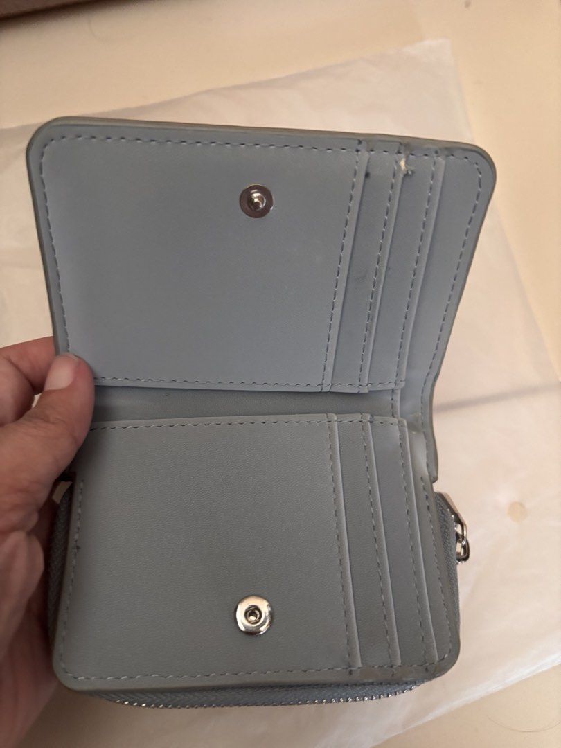 Pull & Bear Blue Bi-fold Wallet (Category: Wallets & Card holders) located in Pasig City. Submitted by bookishnook (Listing ID 1460771939, Image 2). Description: - Cute blue wallet from Pull & Bear - Features card slots - Includes a coin compartment with a zip - Secure snap button closure - Small and compact design, fits easily in any bag - Ideal for everyday use.