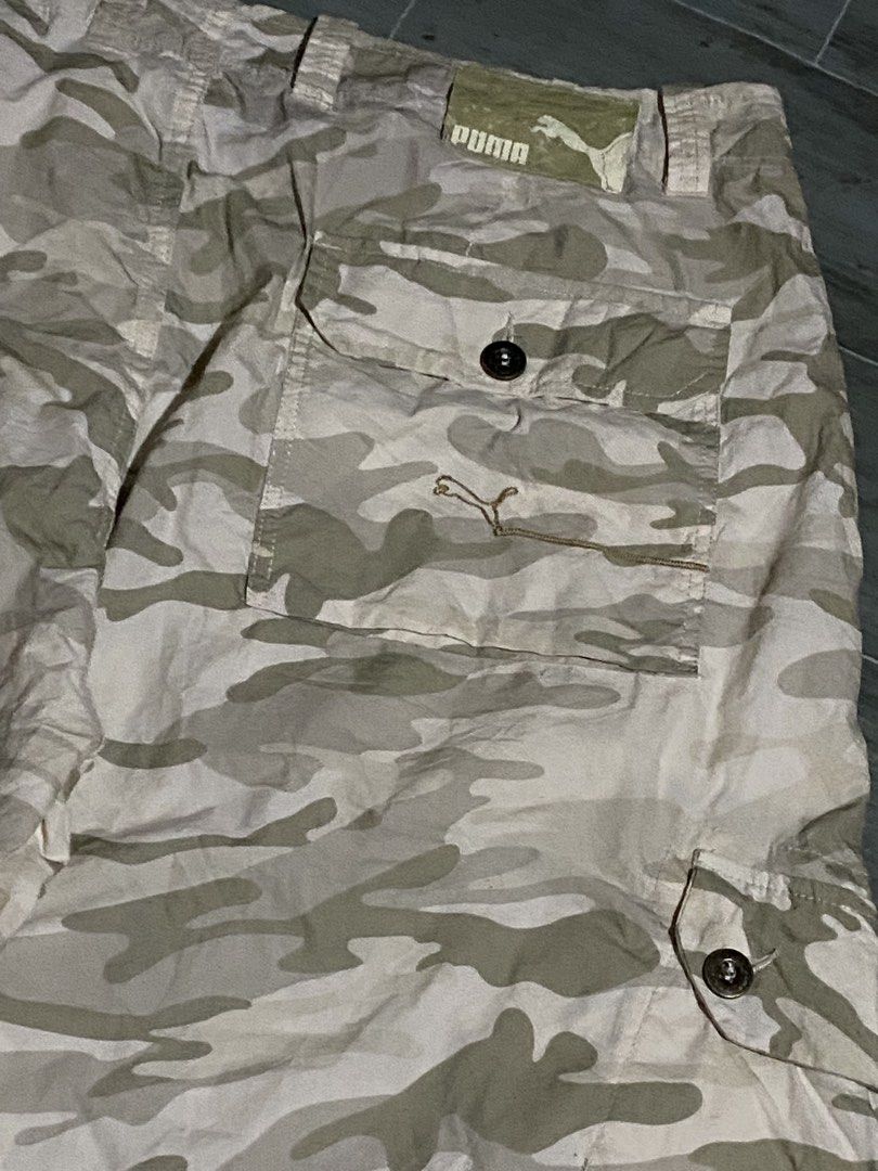 Puma Camo Cargo Shorts (Category: Shorts) located in Davao. Submitted by singkorayk15407 (Listing ID 1460903636, Image 3). Description: - Cool Puma camouflage cargo shorts - Multiple pockets for ample storage - Secure button and zip fly closure - Ideal for casual wear and outdoor adventures - Designed for a comfortable fit.