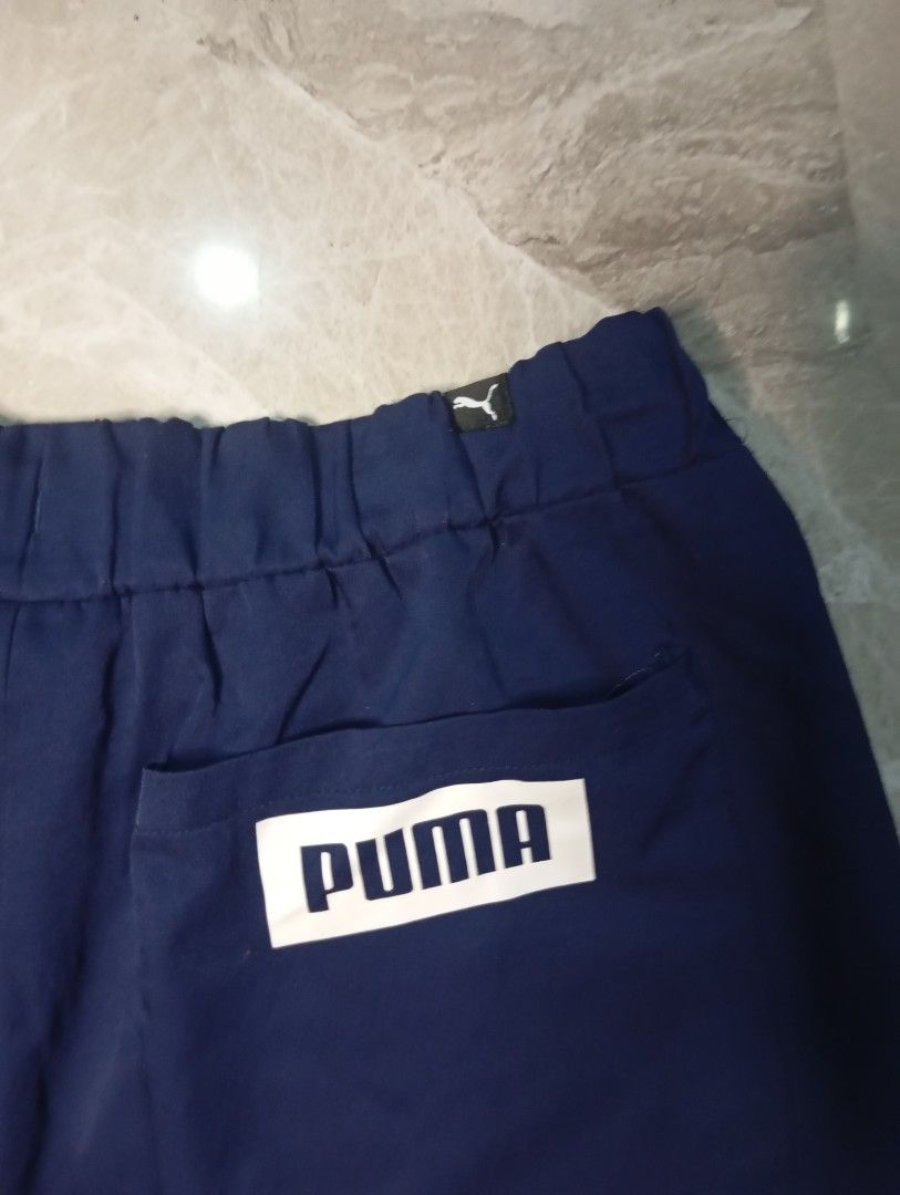 Puma Navy Blue Athletic Shorts Size M (Category: Activewear) located in Quezon City. Submitted by ThriftsPaMore (Listing ID 1460837065, Image 3). Description: - Navy blue Puma Big Script Lightweight shorts - Large Puma logo on left leg - Elastic waistband with drawstring - Pockets included - Size Medium 28-34*18, 11.5 - Ideal for sports or casual wear - 9.5/10 Color Rate - Very Good Condition -Issue: please do check pics, 2Cracks on "P" ; tolerab