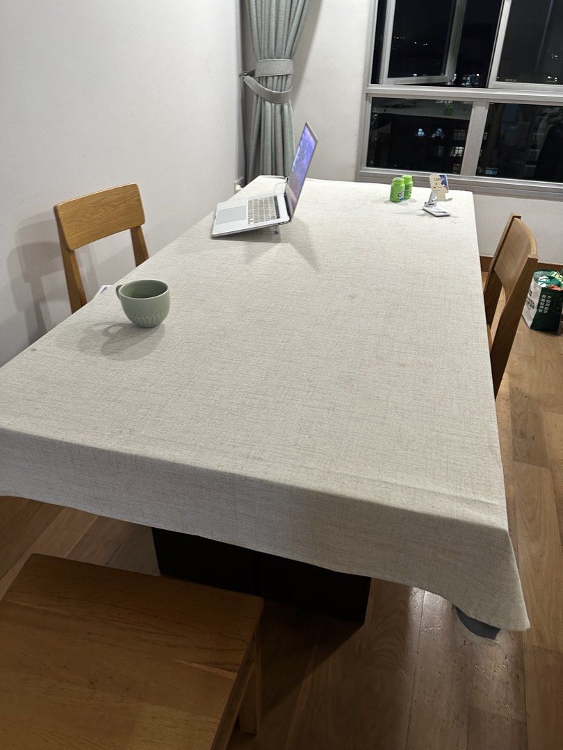 Rectangular Dining Table with Light Grey Tablecloth (Category: Tables & Sets) located in Singapore. Submitted by ruiruiruiruirui (Listing ID 1460742136, Image 1). Description: - Rectangular dining table - Dark base - Light grey tablecloth included - Accompanied by wooden chairs - Versatile for dining or work sessions.