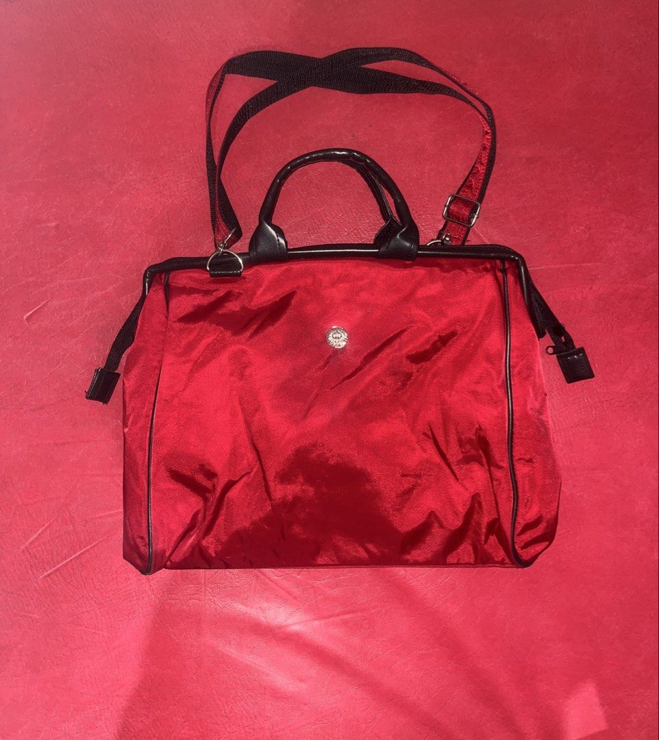 Red handbag (Category: Briefcases) located in Davao. Submitted by janna_soleil (Listing ID 1460876581, Image 1). Description: structured red handbag featuring black top handles and a small circular silver-tone accent in the center.
