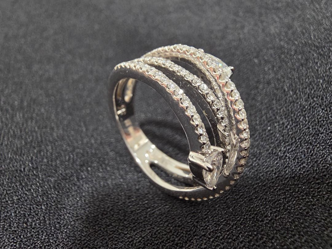 RF Diamond Ring - Unique Wrap Design (Category: Luxury Accessories) located in Cordon. Submitted by jrluxurs (Listing ID 1460890343, Image 3). Description: - Beautiful wrap-around ring design. - Features multiple rows of small, sparkling stones. - Two prominent pear-shaped stones. - Intricate detailing on the band. - Catches the light beautifully. - Perfect for adding sparkle to any outfit..