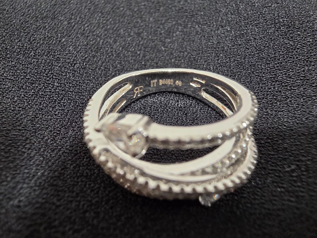 RF Diamond Ring - Unique Wrap Design (Category: Luxury Accessories) located in Cordon. Submitted by jrluxurs (Listing ID 1460890343, Image 1). Description: - Beautiful wrap-around ring design. - Features multiple rows of small, sparkling stones. - Two prominent pear-shaped stones. - Intricate detailing on the band. - Catches the light beautifully. - Perfect for adding sparkle to any outfit..