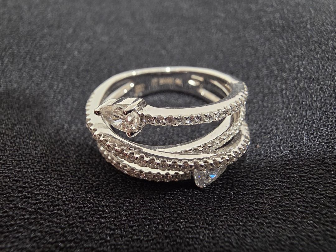 RF Diamond Ring - Unique Wrap Design (Category: Luxury Accessories) located in Cordon. Submitted by jrluxurs (Listing ID 1460890343, Image 2). Description: - Beautiful wrap-around ring design. - Features multiple rows of small, sparkling stones. - Two prominent pear-shaped stones. - Intricate detailing on the band. - Catches the light beautifully. - Perfect for adding sparkle to any outfit..