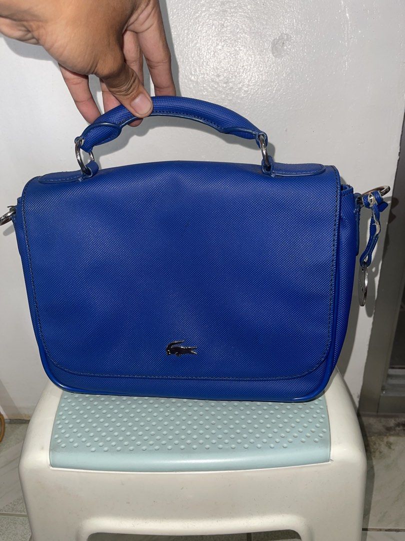 royal blue Lacoste crossbody bag (Category: Luxury Bags & Wallets) located in Manila. Submitted by john_robert00 (Listing ID 1460890384, Image 1). Description: royal blue Lacoste crossbody bag Issue : crack leather sa loob pm sa details. .