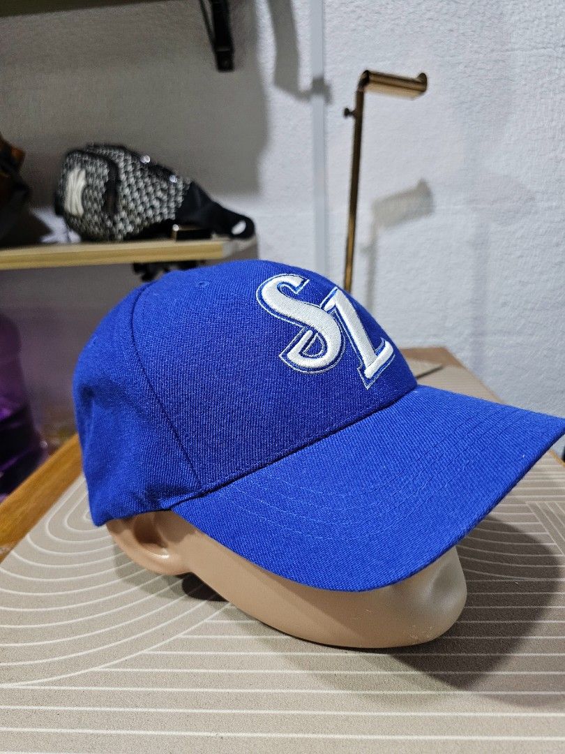 Samsung Lions baseball cap (Category: Caps & Hats) located in Baguio. Submitted by kayeonlineshop (Listing ID 1460758730, Image 2). Description: This is a blue Samsung Lions baseball cap featuring a prominent embroidered white and blue "SL" logo on the front.
