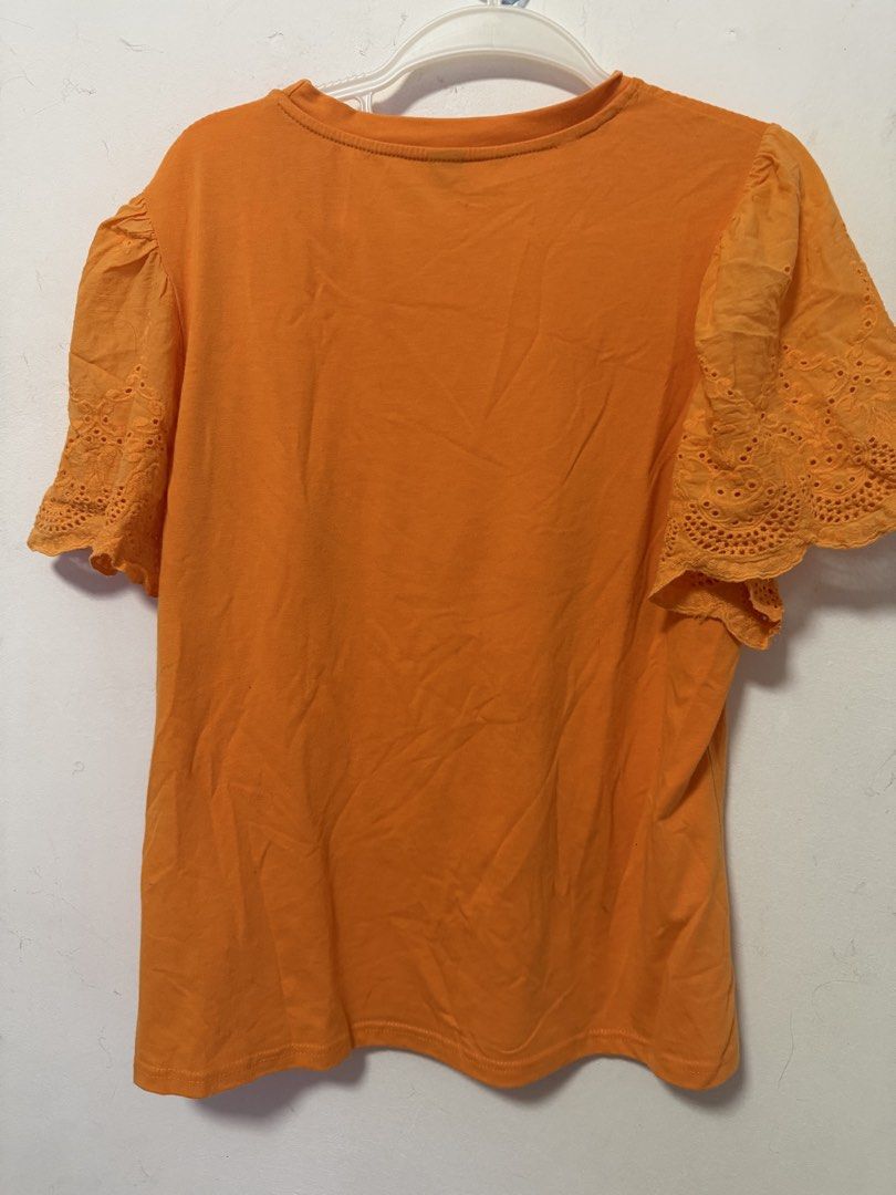 SHEIN Orange Eyelet Top (Category: Blouses) located in Paranaque City. Submitted by zen.dycluttering (Listing ID 1460863038, Image 2). Description: - SHEIN Curve Orange T-shirt - Size: 2XL on tag but can fit XL - Cute eyelet details on sleeves.