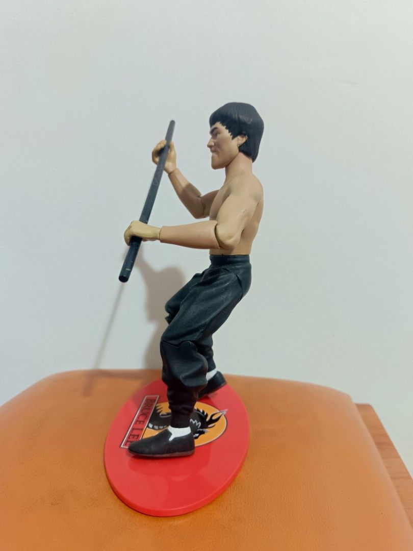 Sideshow toy Bruce Lee Action Figure with Display Base (Category: Figurines & Statues) located in Muntinlupa City. Submitted by kencasia (Listing ID 1460790449, Image 2). Description: - Bruce Lee action figure - Red display base with dragon logo and 'Bruce Lee' name - Articulated joints for dynamic posing - Ideal for collectors and martial arts fans.