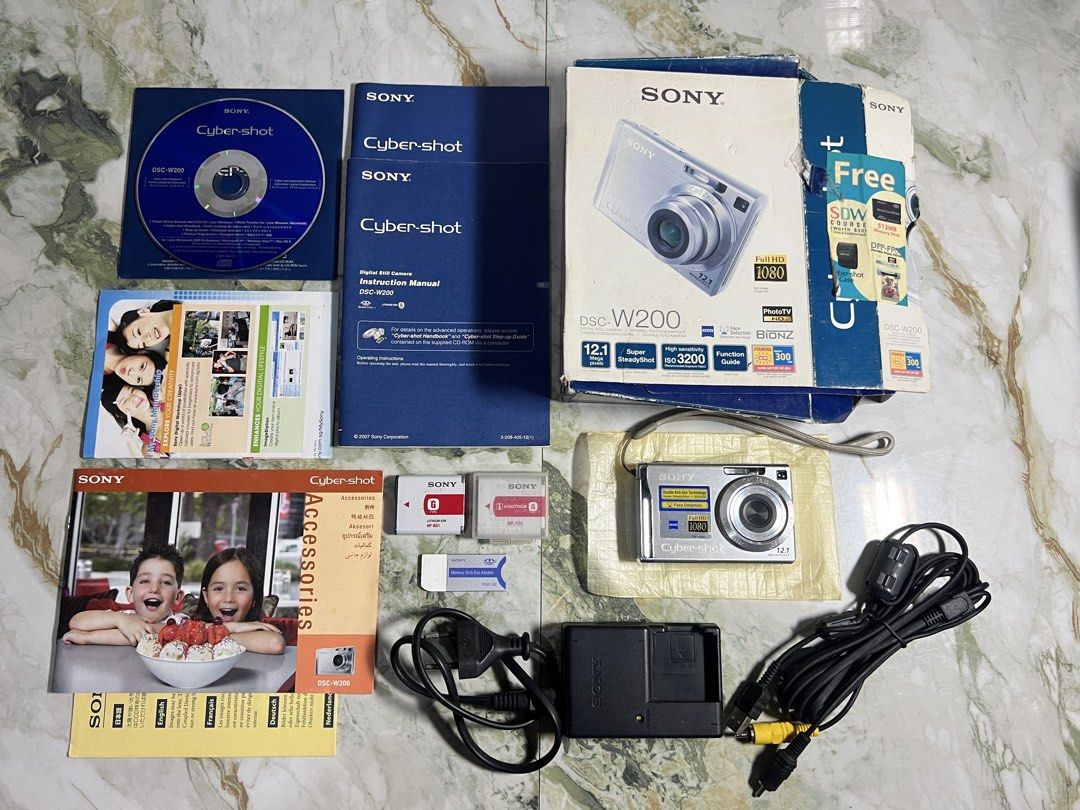 *Sony DSC-W200 - 12.1 MP (Category: Cameras) located in Subic. Submitted by thrifters_23 (Listing ID 1460865215, Image 1). Description: *Sony DSC-W200 - 12.1 MP Condition: - pre-owned - tested & working - clean output - visible dirt & scratches on lcd (doesn’t affect the output) - no functional issues Body: - 7.5/10 (few signs of usage) Inclusion: (complete) - unit - 2 battery - 8 gb memory card - strap - og box - pouch - manuals - memory stick d