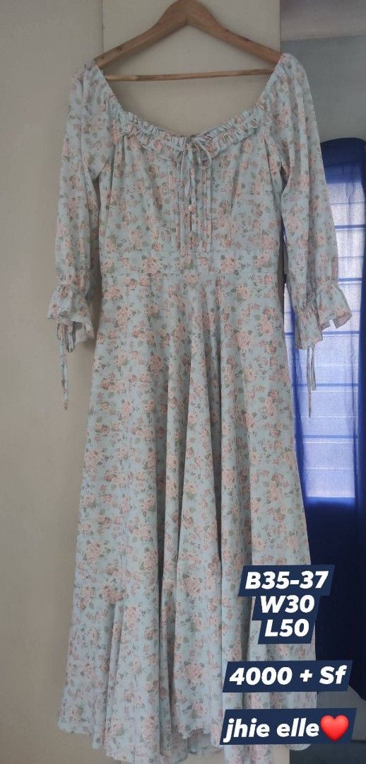 Soon Manila Adrianna (Category: Dresses) located in Bacolod City. Submitted by leighleigh17 (Listing ID 1460884902, Image 3). Description: - Light blue maxi dress with pink floral print - Square neckline with ruffles and tie-up detail - Long puff sleeves with ruffled cuffs - Fitted bodice and flowy A-line skirt - Perfect for a romantic, vintage-inspired look - Measurements: Bust 35-37 inches, Waist 30 inches, Length 50 inches.