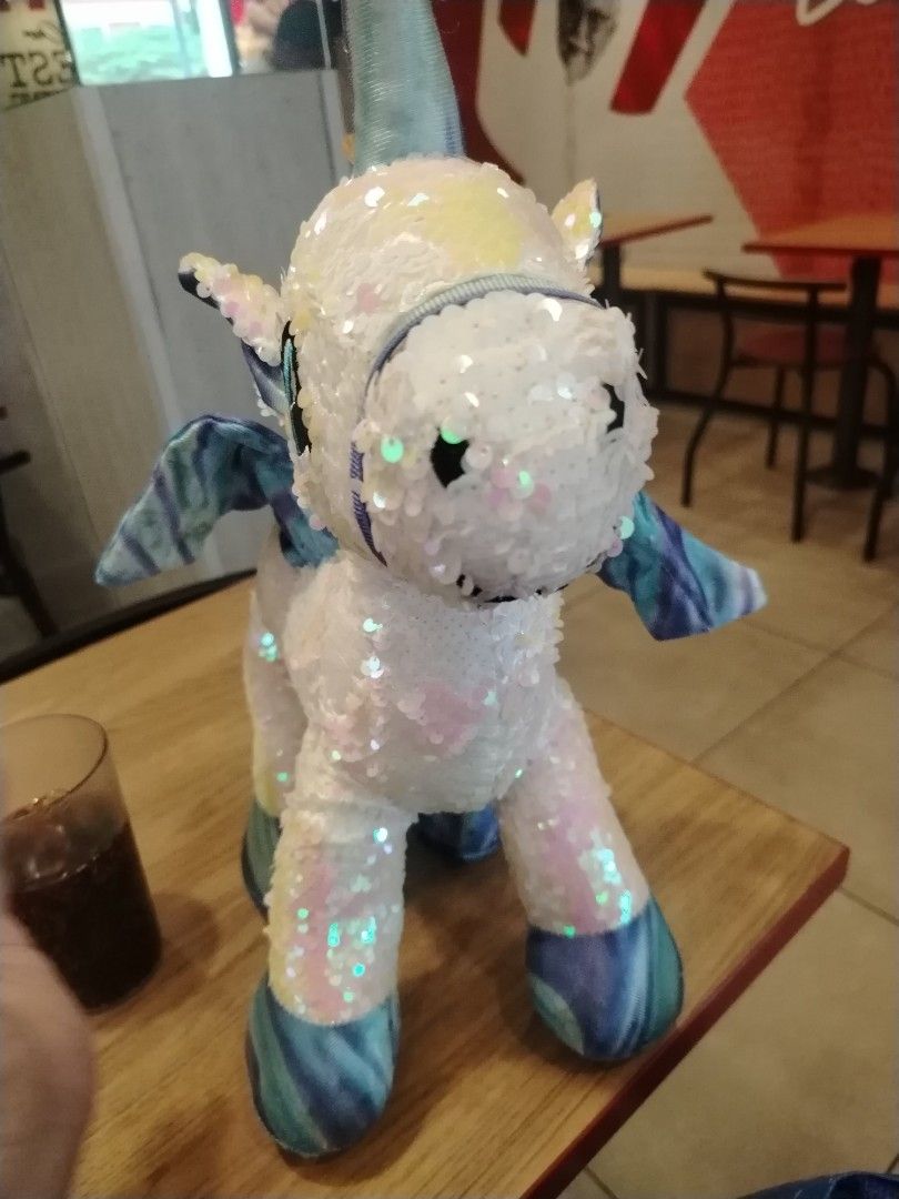 Sparkly Sequin Unicorn Plush Toy with Rainbow Mane (Category: Plushies & Soft Toys) located in Manila. Submitted by purediamond888 (Listing ID 1460796455, Image 2). Description: - Super cute sparkly unicorn plushie - Covered in iridescent sequins - Rainbow colored mane and tail - Blue and purple tie-dye wings - Ideal for kids or as a fun decoration.