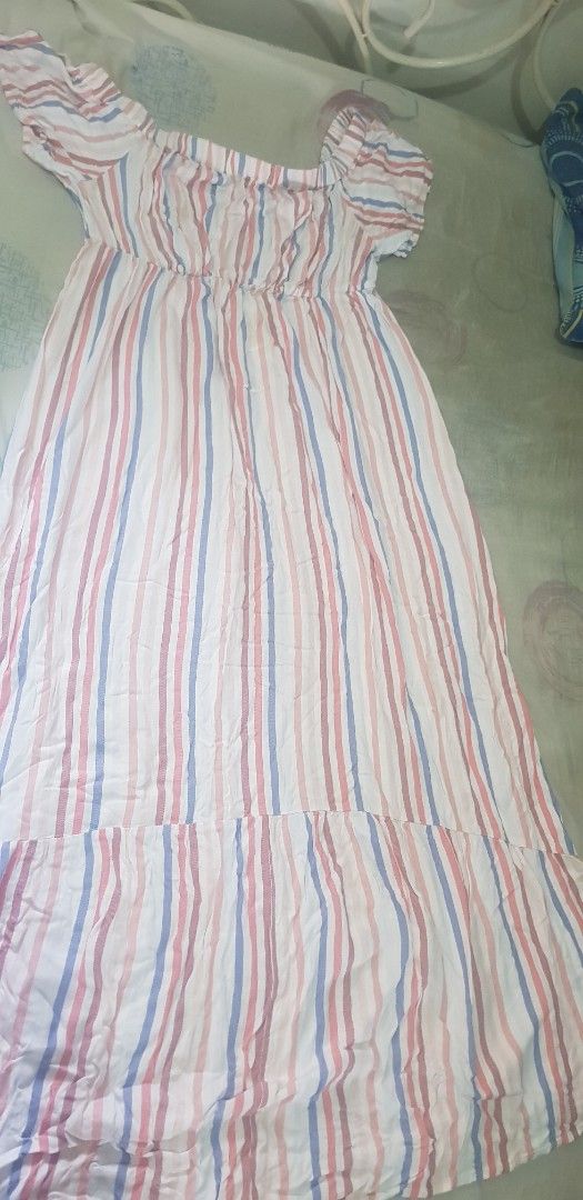 Striped Maxi Dress (Category: Dresses) located in Quezon City. Submitted by seventeenjeonghan (Listing ID 1460772151, Image 2). Description: - White maxi dress with pink and blue stripes - Off-the-shoulder design - Elasticated waist for a comfortable fit - Flowy and breezy fabric - Ideal for casual outings, beach days, or resort wear - Easy to style and wear.
