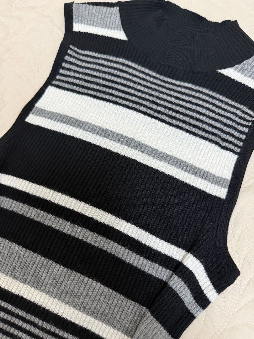Striped Mock Neck Sleeveless Knit Top (Category: Sleeveless) located in Manila. Submitted by aickasomb14373 (Listing ID 1460803658, Image 2). Description: - Chic sleeveless top in black, white, and grey stripes - Stylish mock neck design - Comfortable ribbed knit material - Flattering fitted silhouette with a subtle flare at the hem - Versatile for pairing with jeans or skirts - Ideal for layering or wearing as a standalone piece.