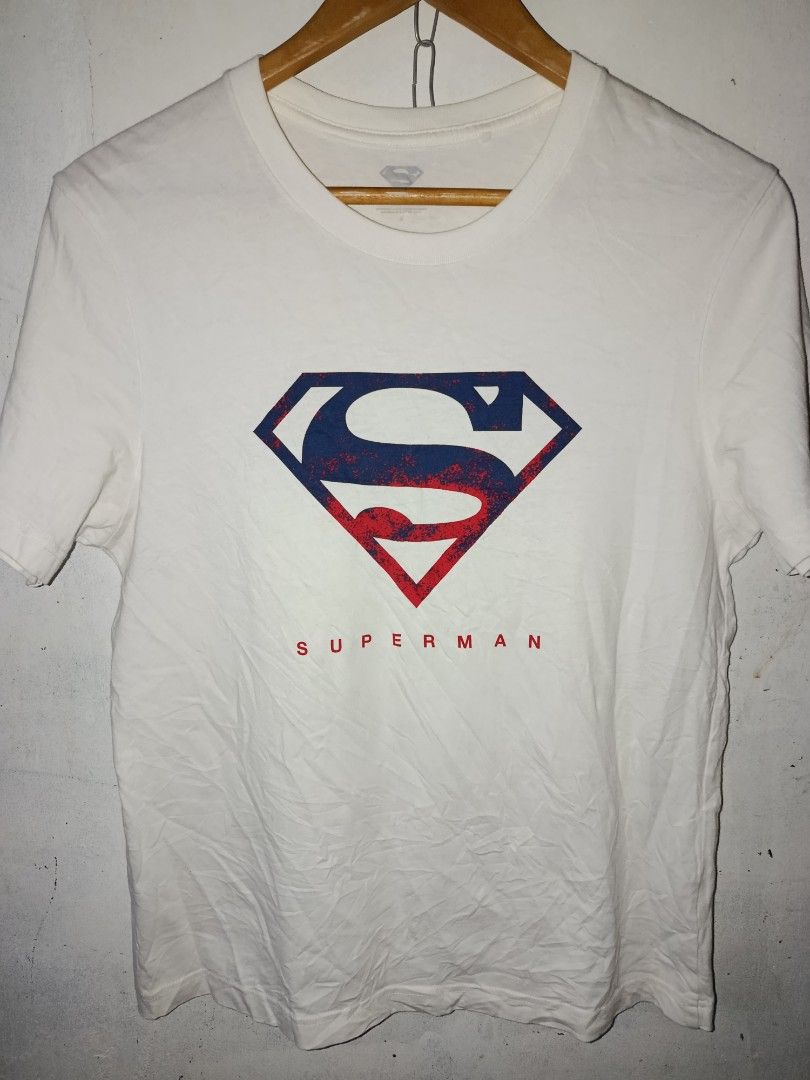 Superman Graphic T-Shirt (Category: Tshirts & Polo Shirts ) located in Nabunturan. Submitted by marmitoren42236 (Listing ID 1460871954, Image 1). Description: - White t-shirt with a cool, distressed red and blue Superman logo graphic. - 'SUPERMAN' text printed below the logo. - Tag shows size S. - Ideal for any Superman fan..