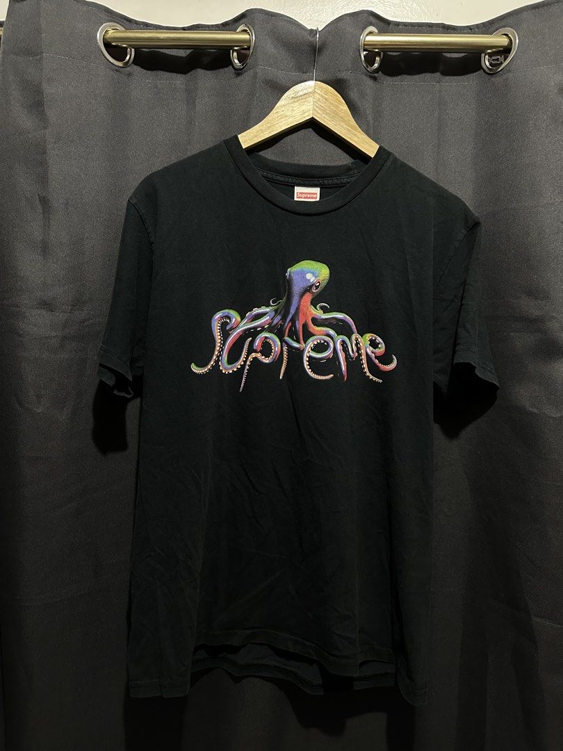 Supreme Tentacles Tee (SS18) (Category: Tshirts & Polo Shirts ) located in Buenavista. Submitted by themodernrack (Listing ID 1460805028, Image 1). Description: Brand: Supreme Color: Black Style: Graphic Tee (Features colorful octopus spellout print on chest) Tag Size: Medium (Fits True to Size) Condition: Good used condition (Light fading on fabric, slight hairline cracking on graphic print) Measurements (Inches): Width (Pit-to-Pit): 20” Length: