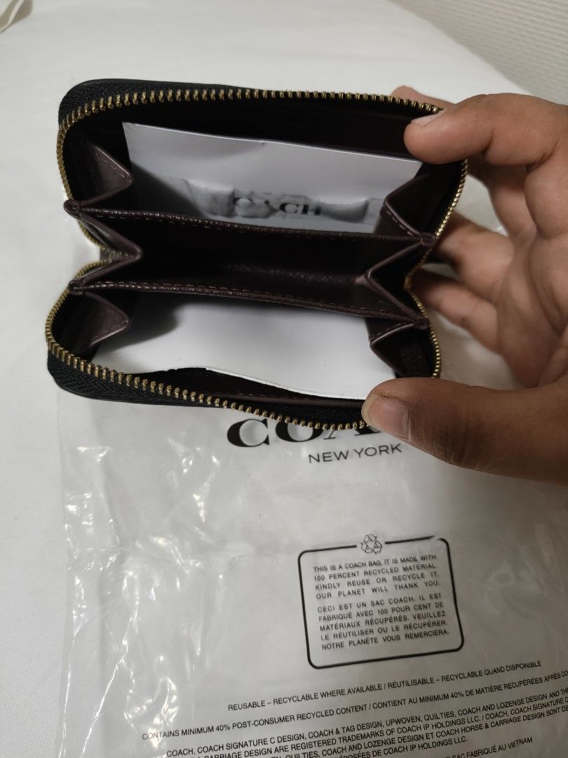 Take all for 1499 (Category: Wallets & Card holders) located in Tuguegarao City. Submitted by ghinzky_preloved (Listing ID 1460761763, Image 2). Description: Coach zip around wallet in black pebbled leather. Gold 'C' logo hardware. Interior has multiple card slots and a zip pocket. Comes in original packaging. Great for keeping essentials organized..