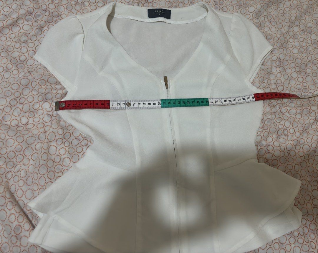 Temt Collection White V-Neck Peplum Blouse (Category: Blouses) located in Lucena. Submitted by lazyqueen29 (Listing ID 1452706981, Image 3). Description: Elevate your everyday look with this elegant white blouse from Zara Basic. Perfect for office wear, casual outings, or smart casual events. Details: * 🤍 Brand: Zara Basic * 🤍 Color: White * 🤍 V-neck design * 🤍 Short sleeves * 🤍 Peplum style (flattering fit) * 🤍 Soft and comfortable fabric 