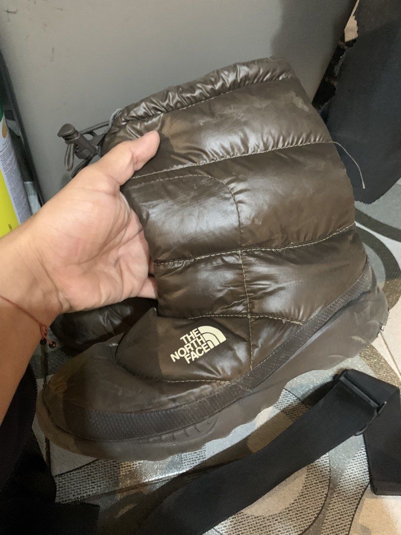 The North Face Puffy Winter Boots (Category: Boots) located in Caloocan City. Submitted by migueljehurvra (Listing ID 1460825156, Image 1). Description: - Brand: The North Face - Color: Brown - Type: Puffy Winter Boots - Features: Great for cold weather, easy slip-on design, excellent sole grip, adjustable drawstring top - Ideal for: Outdoor adventures, keeping warm.