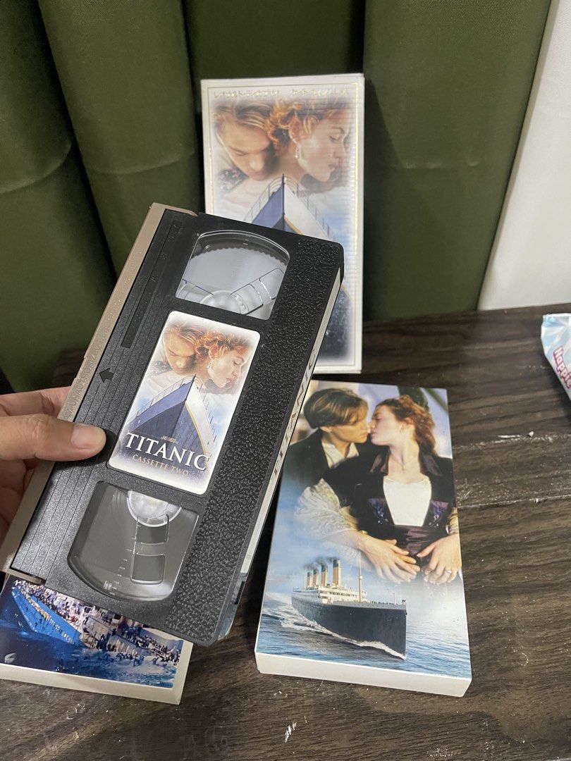 Titanic VHS Cassette Set - Two Tapes (Category: CDs & DVDs) located in San Pedro. Submitted by jingay81 (Listing ID 1460840795, Image 2). Description: - Relive the epic romance and drama of Titanic on VHS. - Includes both Tape One and Tape Two. - Features the iconic movie artwork. - Perfect for collectors or fans of this classic film..