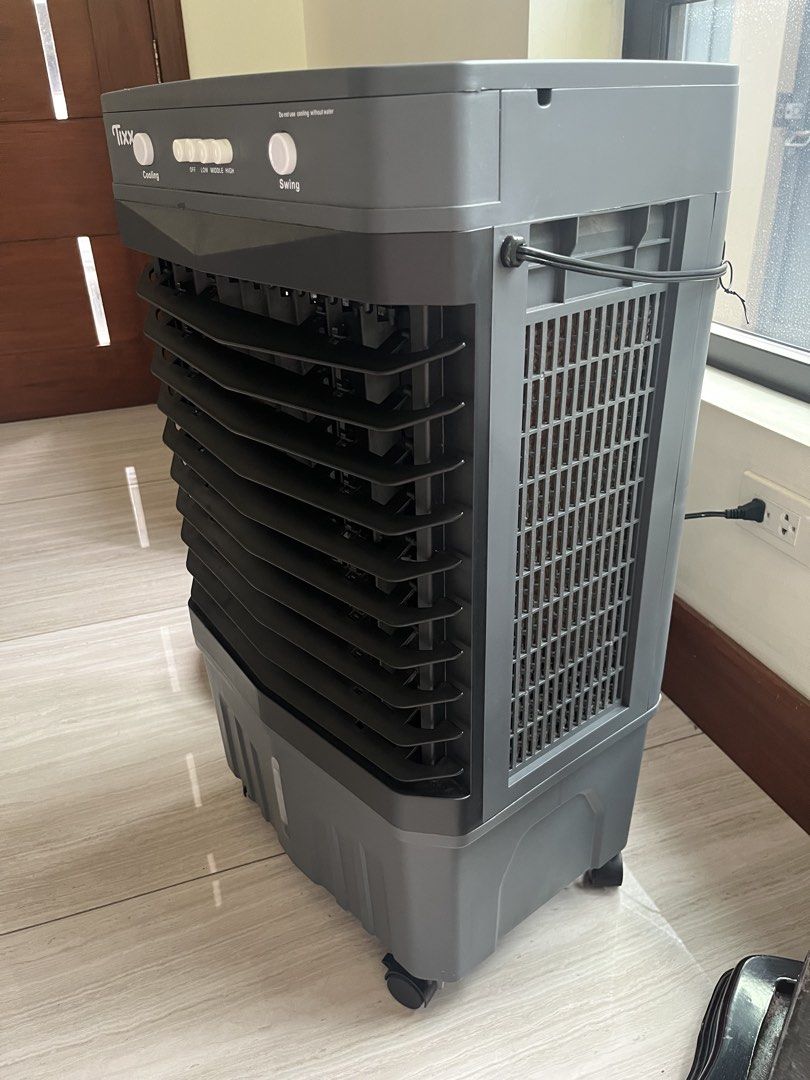 Tixx Air Cooler Fan with Cooling and Swing Function 50L (Category: Air Conditioning and Heating) located in Quezon City. Submitted by ryaneunice76603 (Listing ID 1460725953, Image 2). Description: - Tixx Air Cooler for effective room cooling - Cooling and Swing functions included - Multiple speed settings: Off, Low, Middle, High - Convenient water tank located at the bottom - Proven to work well and keep your room cool - 50L water tank capacity .