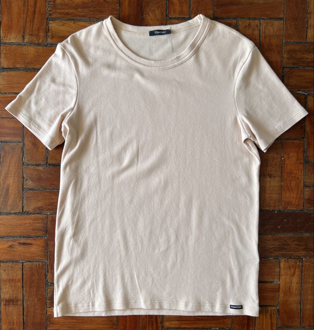 TOM FORD Logo Patch Crew Neck T-Shirt (Category: Luxury Apparel) located in Quezon City. Submitted by raccoonfur (Listing ID 1460839147, Image 3). Description: Tom Ford beige tshirt. Quiet luxury at its core. Beautiful fall and stretch for a very minimalist tshirt. Great condition. Patch logo on left hem. Flat measurements: Pit to pit 45cm/17.75in Length 64.25cm/25.25in Shoulders 42cm/16.5in Sleeve length 18.25cm/7.25in.