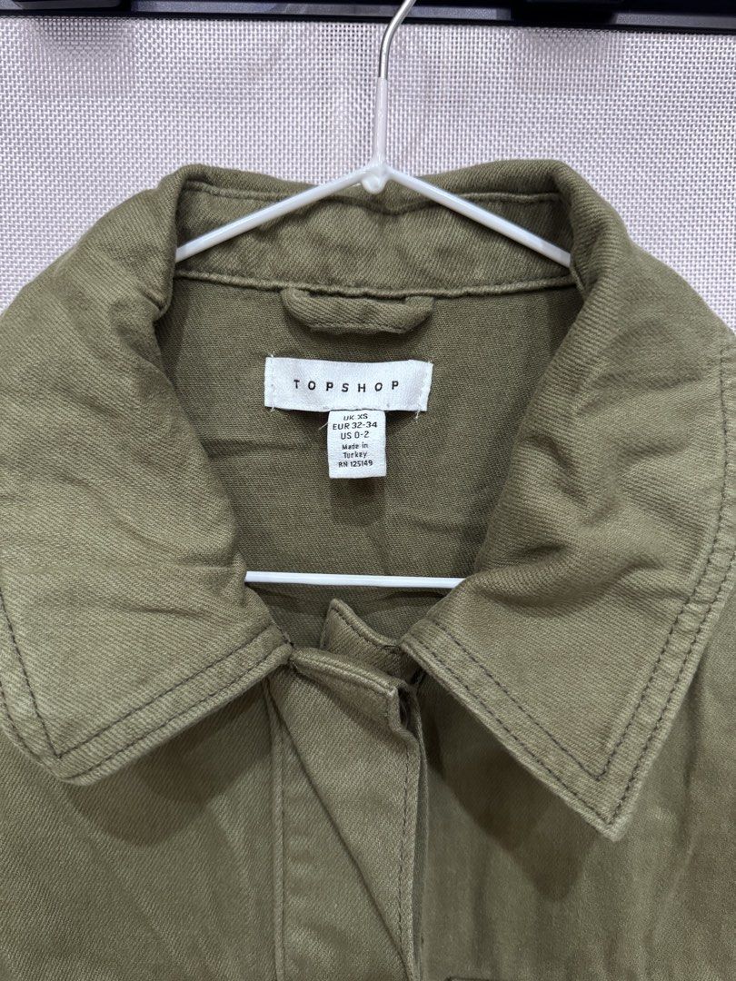TOPSHOP Khaki Utility Jacket with Multiple Pockets (Category: Coats, Jackets and Outerwear) located in Manila. Submitted by altabl123 (Listing ID 1460877134, Image 2). Description: - Khaki green utility jacket from Topshop - Button-up front with a classic collar - Multiple functional pockets on the front - Long sleeves with adjustable button cuffs - Ideal for versatile layering - Proudly made in Turkey.