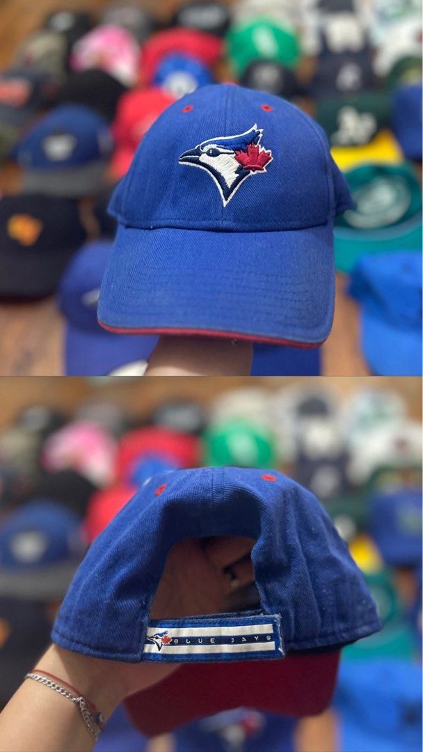 Toronto Blue Jays Baseball Cap (Category: Caps & Hats) located in Manila. Submitted by charmaigne60880 (Listing ID 1460812886, Image 1). Description: - Blue baseball cap featuring the Toronto Blue Jays logo embroidered on the front. - 'Blue Jays' text embroidered on the back. - Red trim detail on the brim. - Perfect for any Toronto Blue Jays fan!.