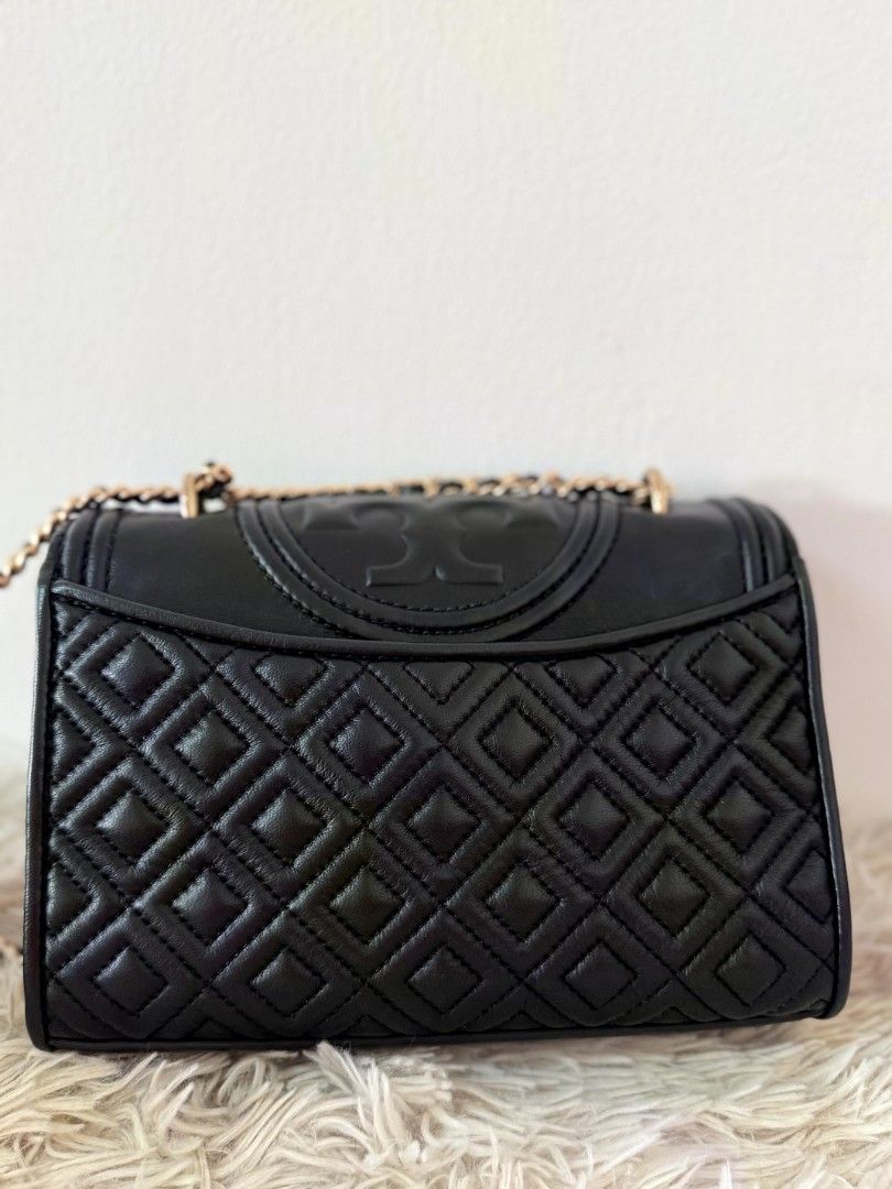 Tory Burch Black Quilted Leather Chain Shoulder Bag (Category: Luxury Bags & Wallets) located in Caloocan City. Submitted by mylove326 (Listing ID 1460801019, Image 2). Description: -Original Tory Burch Fleming -Black quilted leather shoulder bag - Signature Tory Burch logo - Gold chain strap - Tassel detail - Measurements: L 20cm x H 14cm x W 6cm - Versatile for day or night use -Can use as shoulder bag or body bag.. -Good as New -Used once or t