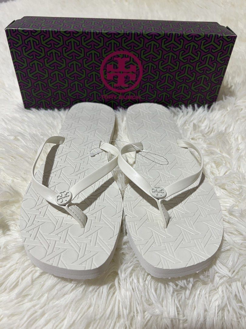 Tory Burch "Canning Emboss" Flip Flops - Size 9 (Category: Slippers and slides) located in Guagua. Submitted by boniscloset (Listing ID 1460738484, Image 1). Description: - Authentic White Tory Burch Flip Flops - Classic Embossed Tory Burch Pattern - Size: US 9 - Comes with Original Box - Ideal for Beach Days & Casual Outings.