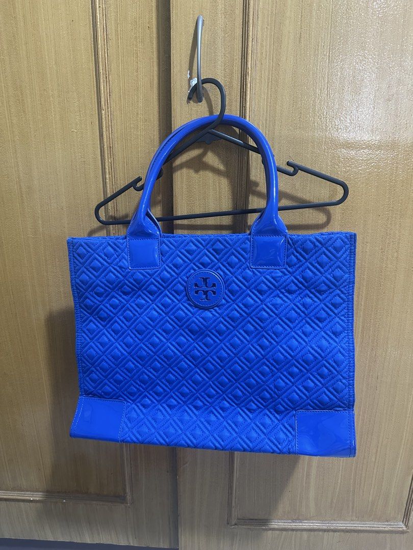 Tory Burch Ella Quilted Tote Bag (Category: Luxury Bags & Wallets) located in Paranaque City. Submitted by shopnichoppy (Listing ID 1460739648, Image 3). Description: - Vibrant blue Tory Burch Ella Quilted Tote - Spacious design - Signature quilted exterior with Tory Burch logo - Interior features multiple pockets and a zippered compartment for organization - Sleek patent leather trim and handles - Ideal for everyday use or travel.