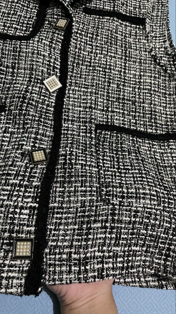 Tweed Vest with Pearl Buttons (Category: Sleeveless) located in Manila. Submitted by myth.rifts (Listing ID 1460840441, Image 2). Description: - Stylish black and white tweed vest - Elegant black trim detail - Beautiful pearl-embellished buttons - Two functional front pockets - Sleeveless design for easy layering - Versatile piece to elevate any outfit - Approximate measurements: 17 inches (length), 16 inches (chest).