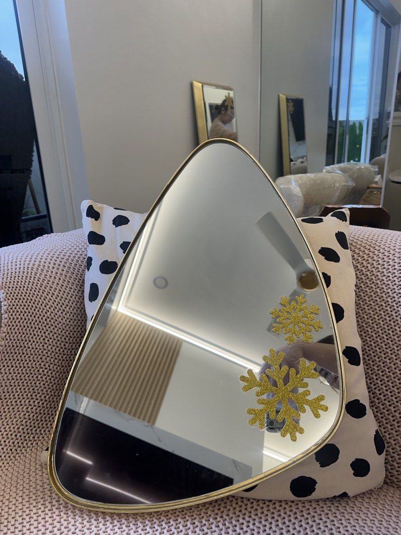 Unique Teardrop Gold Mirror with Snowflake Decals (Category: Mirrors) located in Pasay City. Submitted by behua (Listing ID 1460731440, Image 1). Description: - Unique teardrop-shaped mirror - Elegant gold frame - Adorned with sparkly snowflake decals - Soft black velvet backing - Ready to hang - Dimensions: Approximately 14 inches tall - Ideal for bedrooms, entryways, or as a decorative accent.