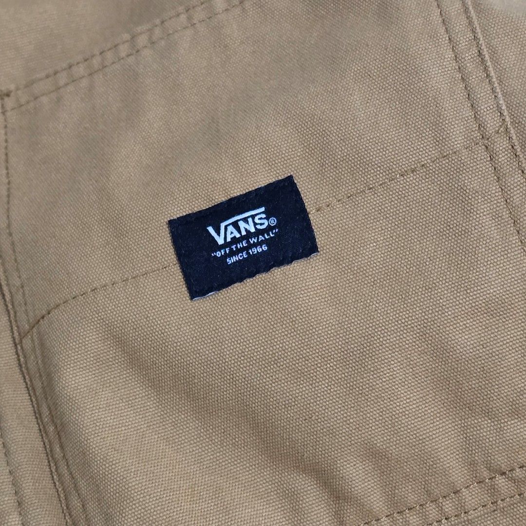 Vans Sherpa Lined Workwear Jacket Tan (Category: Coats, Jackets and Outerwear) located in Manila. Submitted by nnthrift_ (Listing ID 1454678789, Image 3). Description: - Tan Vans workwear jacket - Sherpa lined collar and interior for warmth - Button-up front with convenient chest pockets - Iconic Vans logo patch on the right chest - Ideal for staying cozy in cooler weather.