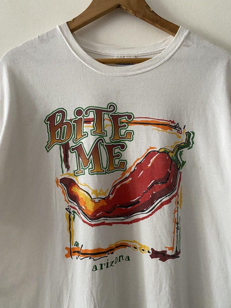 Vintage Y2K "Bite Me" Chili Pepper Graphic Tee (Category: Tshirts & Polo Shirts ) located in Quezon City. Submitted by rlphvncntbs (Listing ID 1460754232, Image 2). Description: Vintage Y2K "Bite Me" Chili Pepper Graphic Tee Size: Large Measurements: 22" x 29" Flaws: Light Stains (Removable) Still in Good Condition Hanes Comfort Tag ₱800 + SF (Negotiable).
